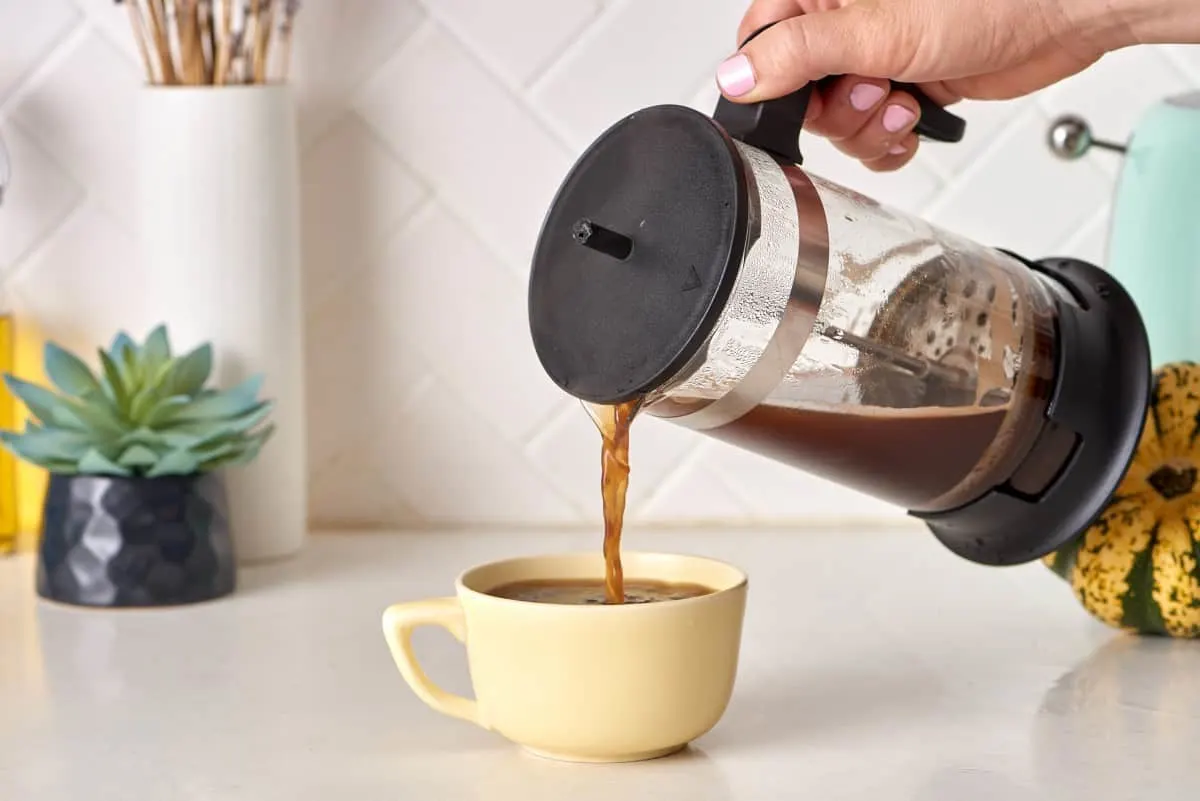 coffee being poured into a coffee cup