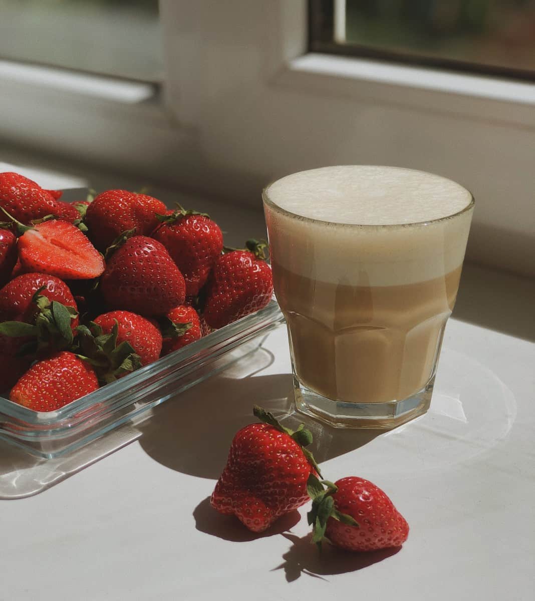 Strawberries and cup of coffee cream