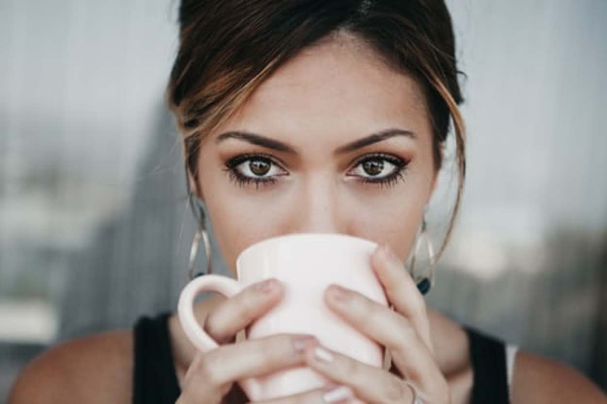 a girl sipping on coffee