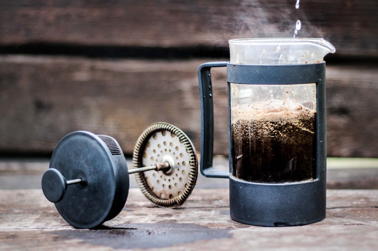 a opened french press with freshly brewed coffee
