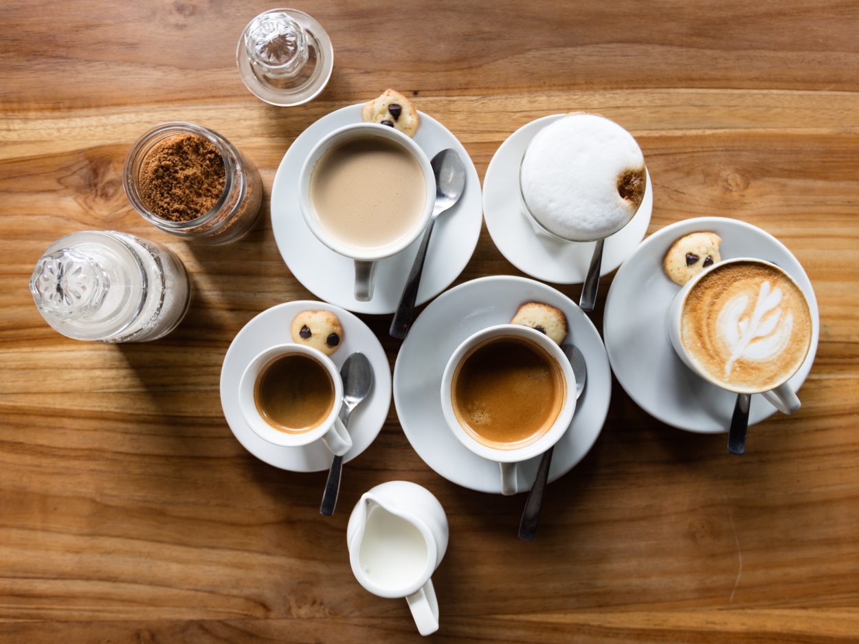 an assortment of coffee and creamers on a table