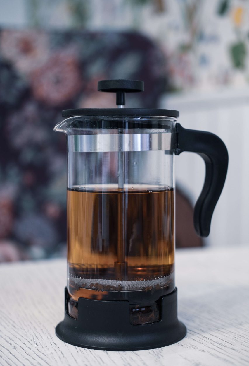 a french press with brewed coffee