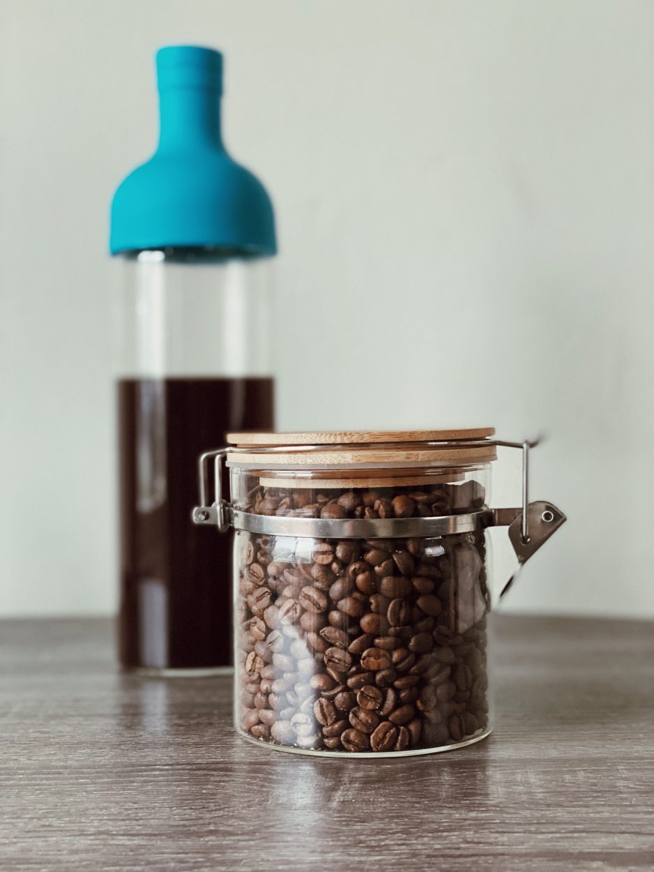 a mason jar with roasted coffee beans stored.