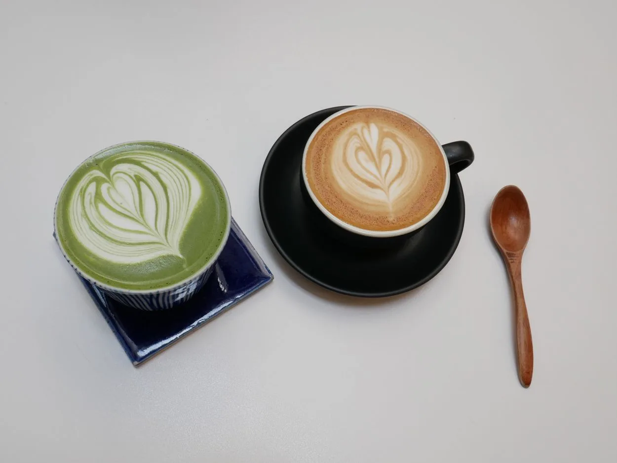 a regular latte next to a matcha latte