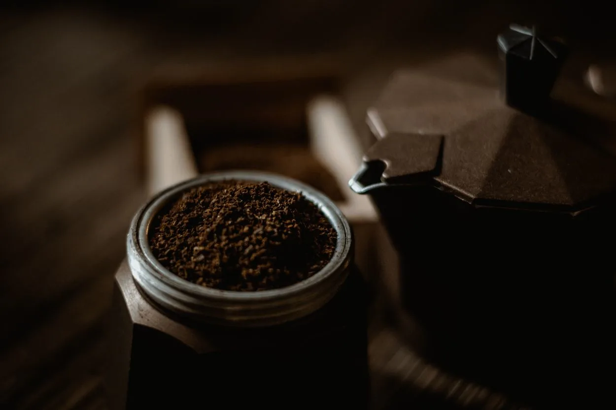 a jar of espresso powder next to a Moka pot