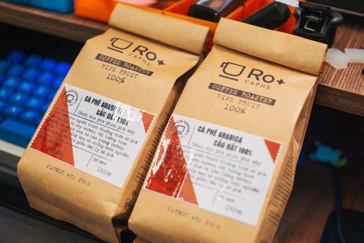 2 bags of a private label coffee product named Ro+ on top of a working table.