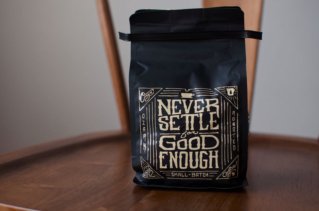 a coffee bag with the words "never settle for good enough" on it 
