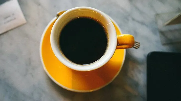 a yellow cup of peruvian coffee