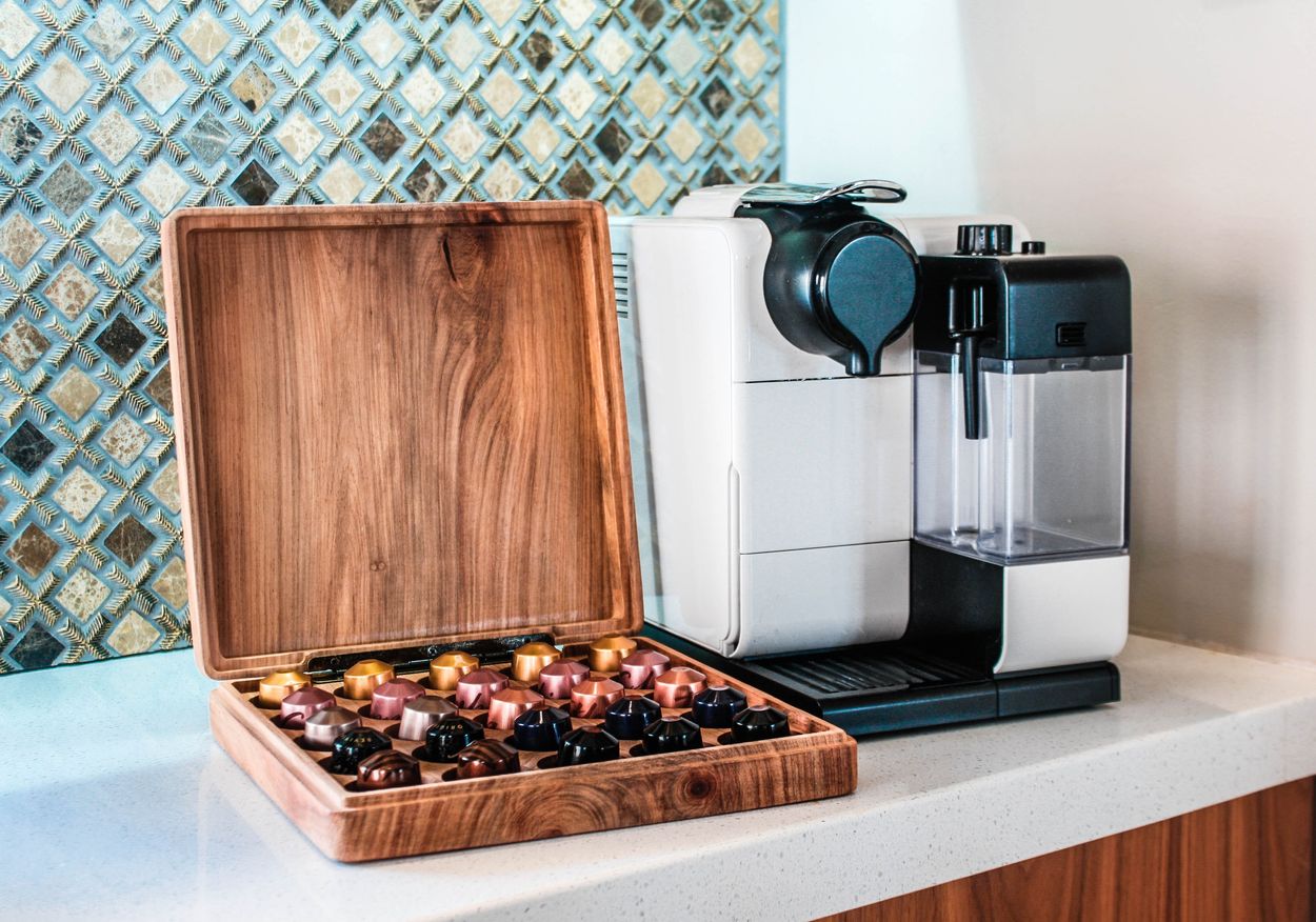 a nespresso machine next to a box of coffee pods