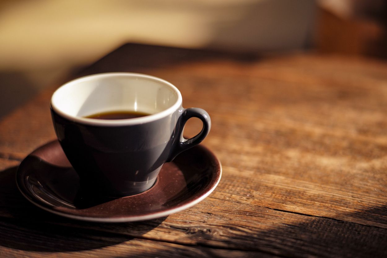coffee in a gray ceramic cup on a wooden table