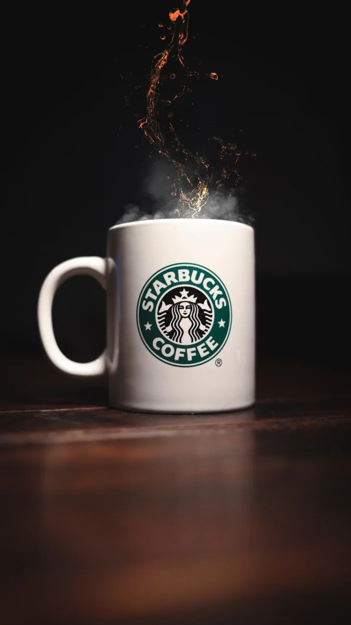 A steaming mug of Starbucks coffee.