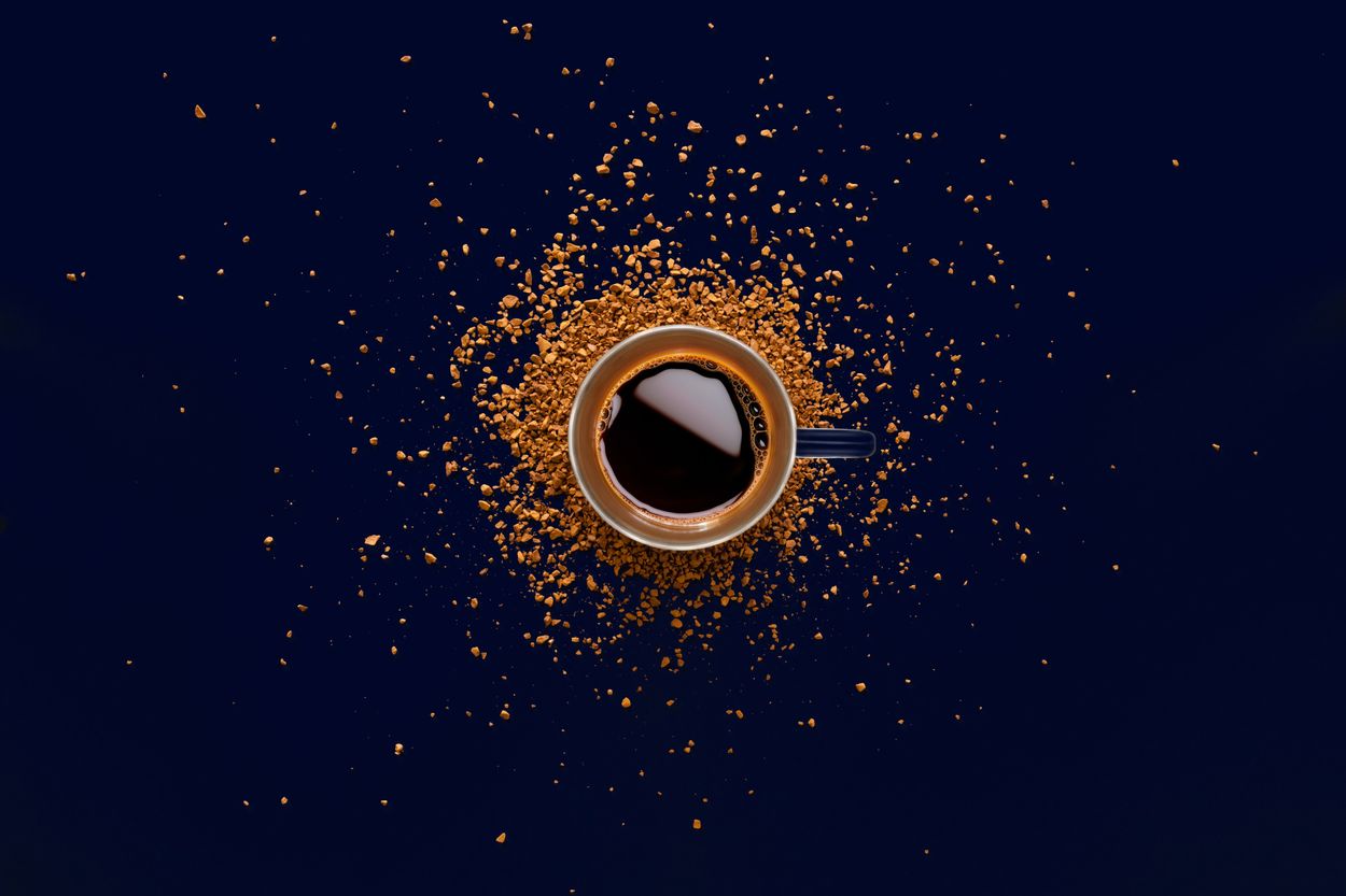 A cup of plain black coffee with dark background.