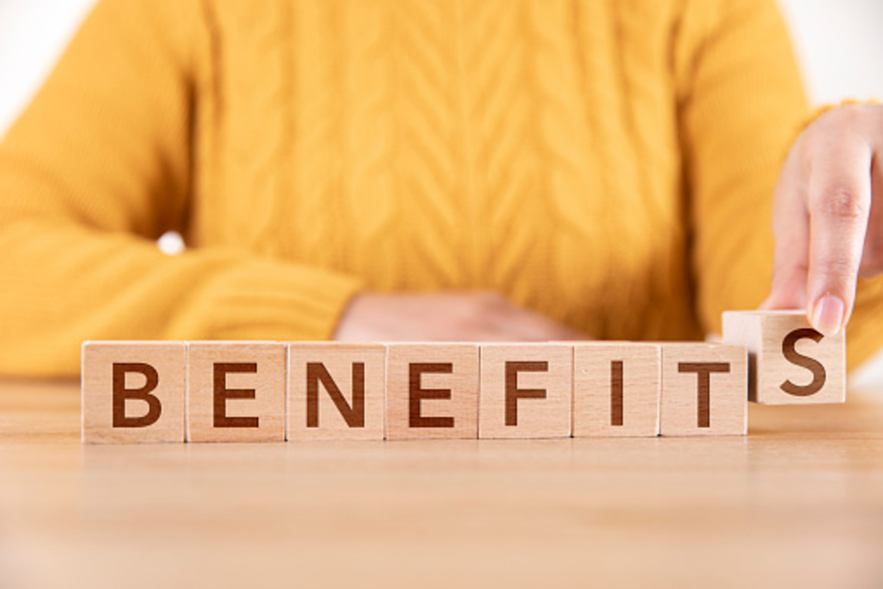 The word "BENEFITS" written with wood blocks