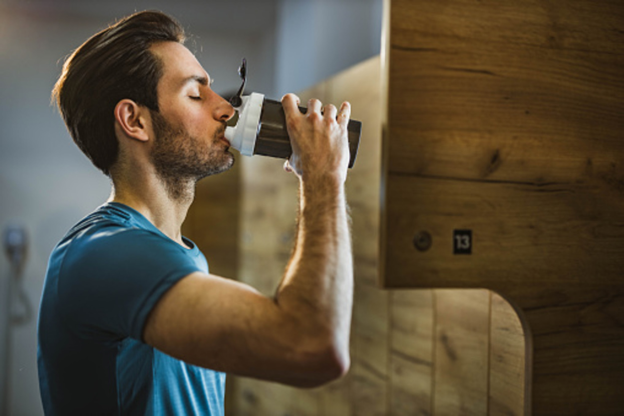 A guy drinking pre-workout