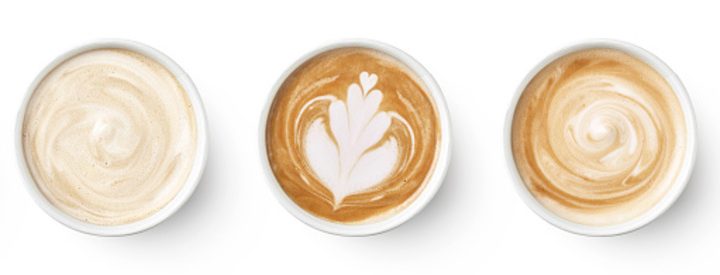 Cups of coffee with different latte art