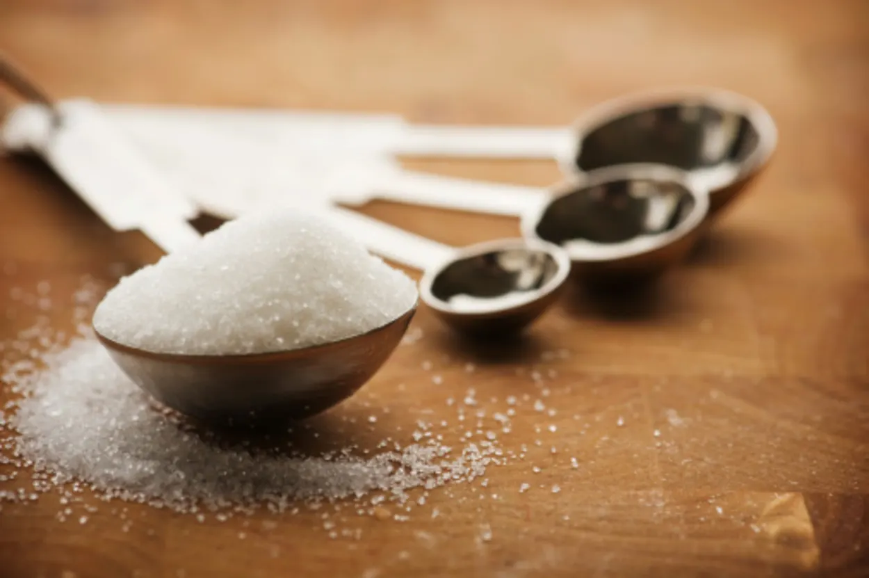 Table spoon filled with granulated sugar