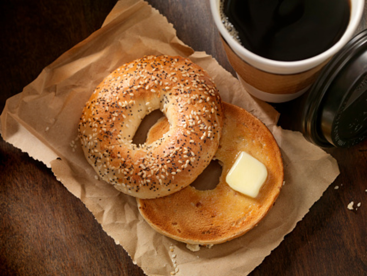 Toasted bagel with butter and a take out coffee