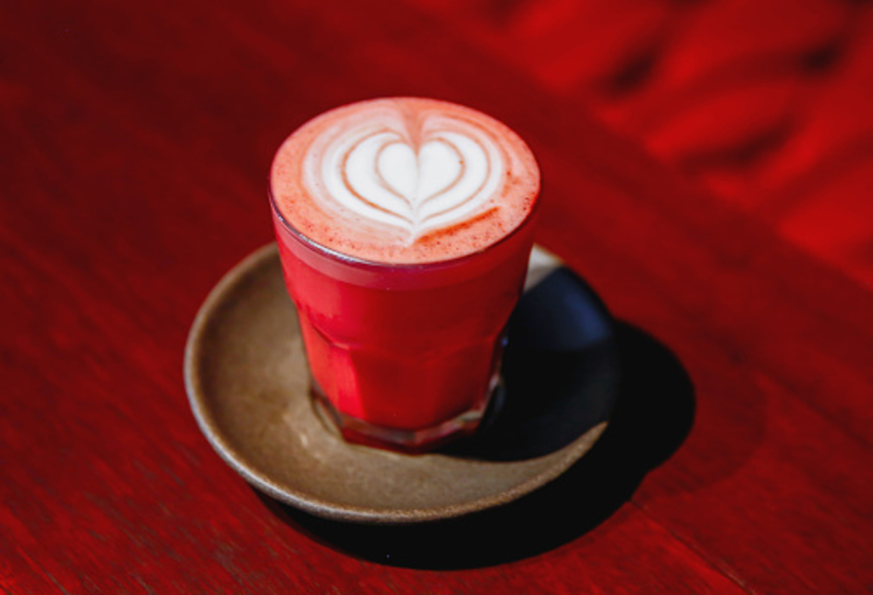 Close up studio shot of red velvet latte art with a heart shape in a coffee shop during Valentine's Day