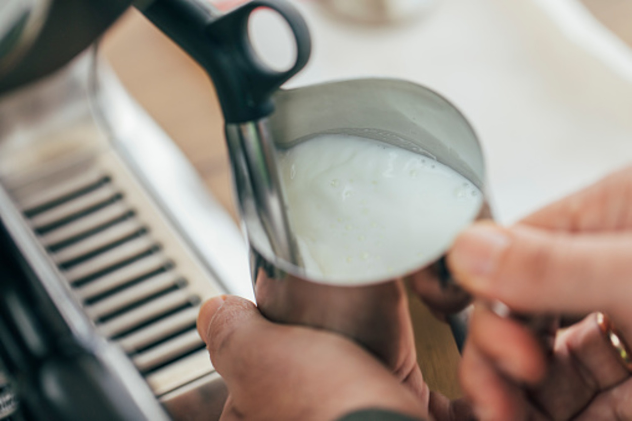 Frothing milk on a coffee machine