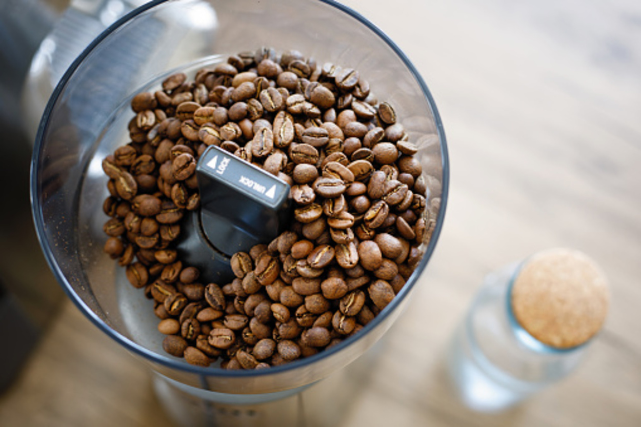 Close up coffee beans in a grinder