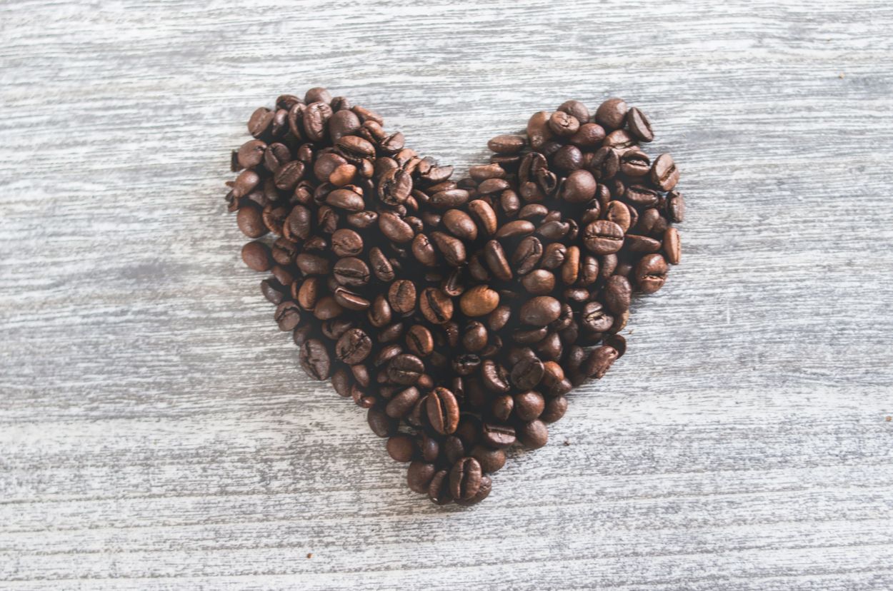 An image of coffee beans in the shape of a heart.